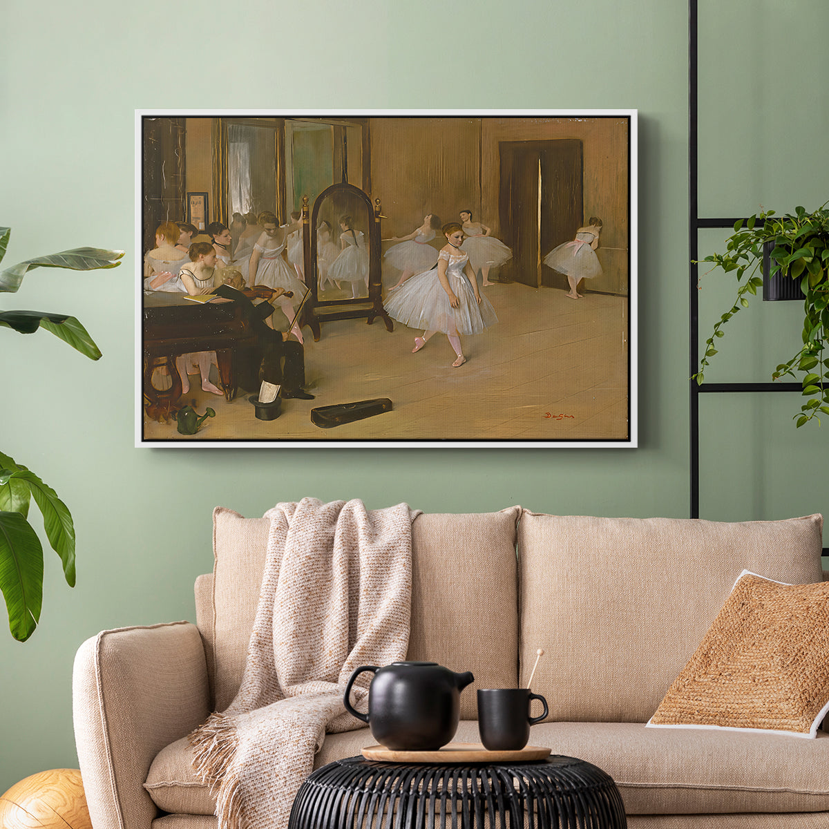 White floater framed canvas featuring a group of dancers mid-practice with teacher overseeing, displayed above a sofa in a modern living room.