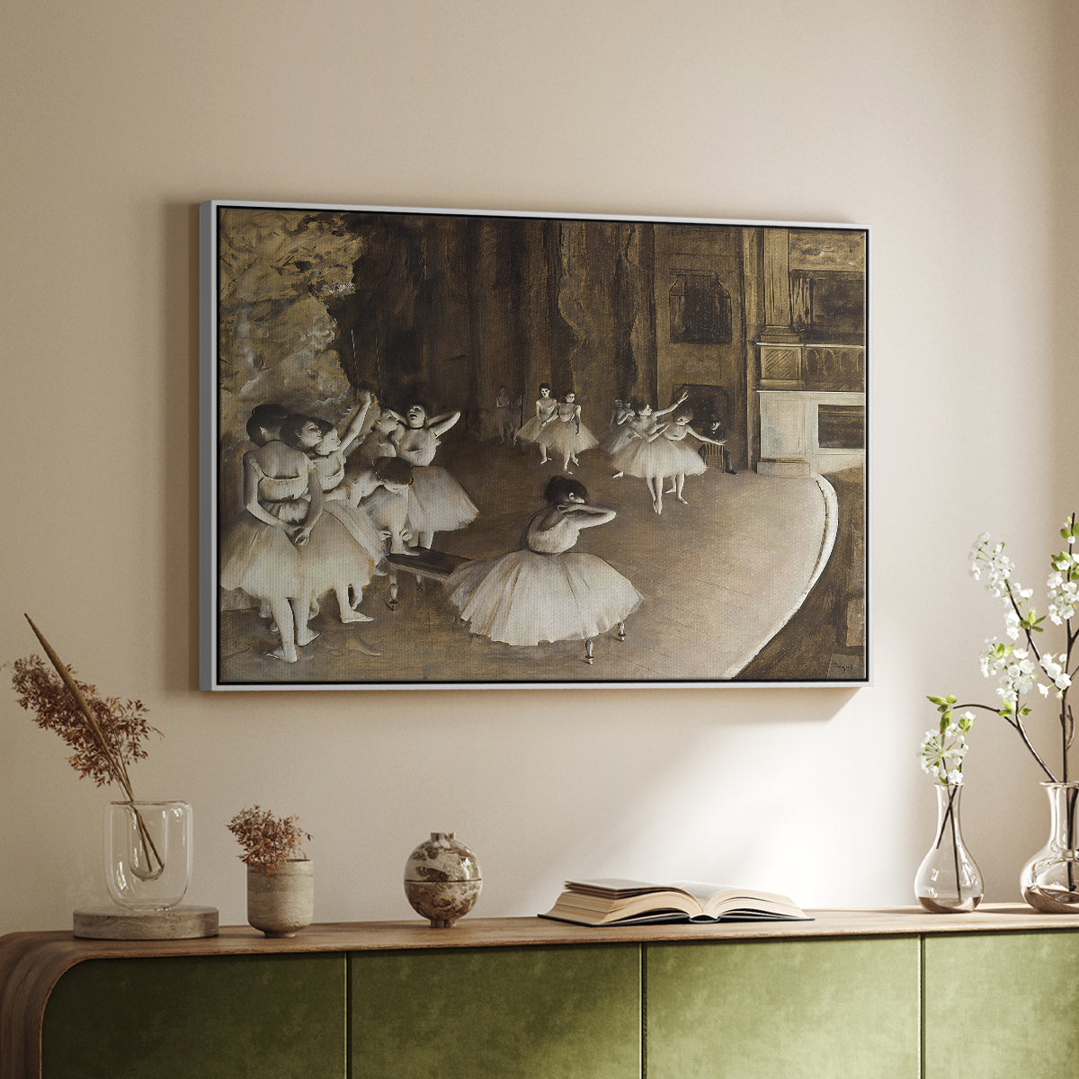 White floater framed canvas of The Rehearsal of the Ballet Onstage, 1874 by Edgar Degas, featuring a stage rehearsal scene with dancers preparing performance above a sideboard in a softly lit hallway.