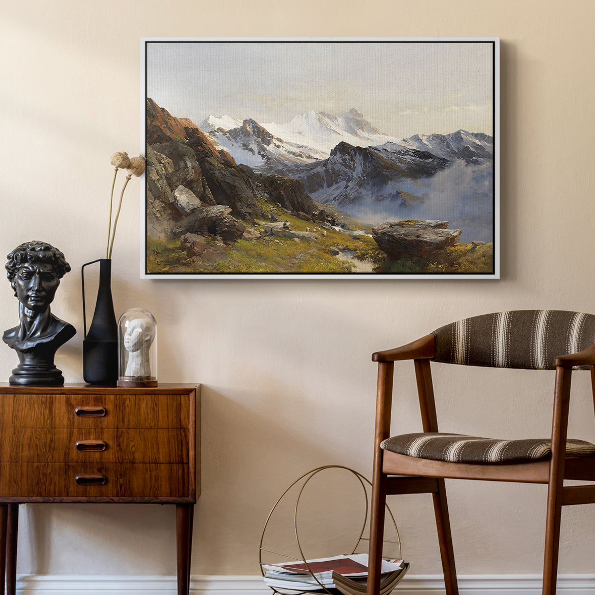 The Großglockner from the Prager Hut, 1890 by Edward Theodore Compton as a white floater framed canvas featuring an alpine vista with towering peak and foreground terrain, styled above a mid-century console in a contemporary living area.