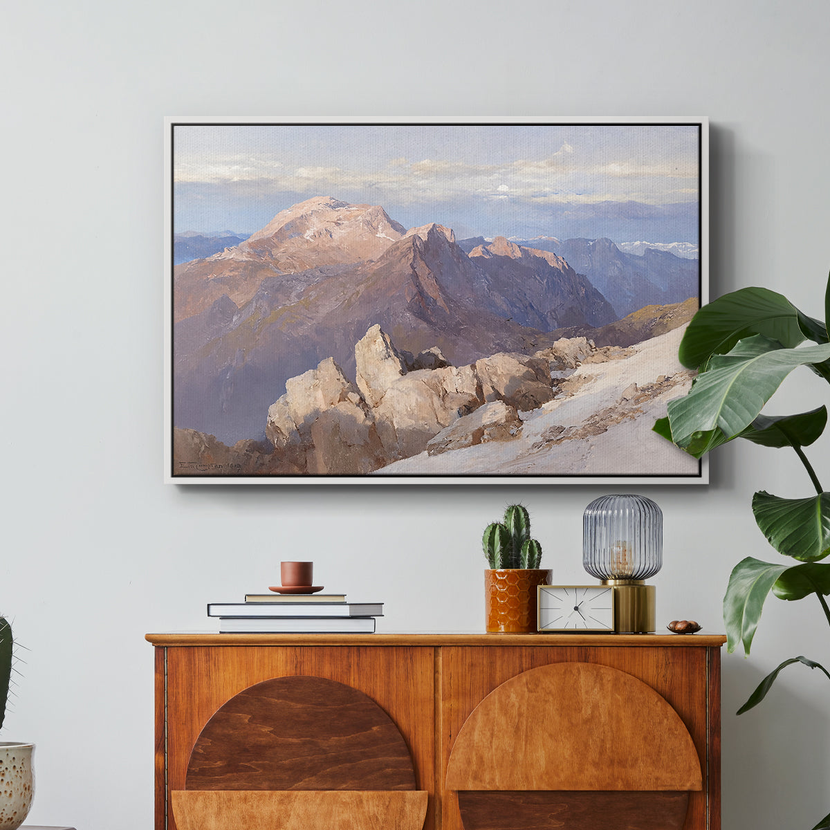 Hoher Göll from Watzmann-Hocheck, 1919 by Edward Theodore Compton in a white floater framed canvas featuring a distant mountain peak viewed from elevated ridge with sweeping landscape, displayed above a wood console cabinet.