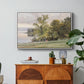 Landscape at Lake Starnberg, 1890 by Edward Theodore Compton in a white floater framed canvas featuring a lakeside landscape with calm water and trees along shoreline, displayed above a wood console cabinet.