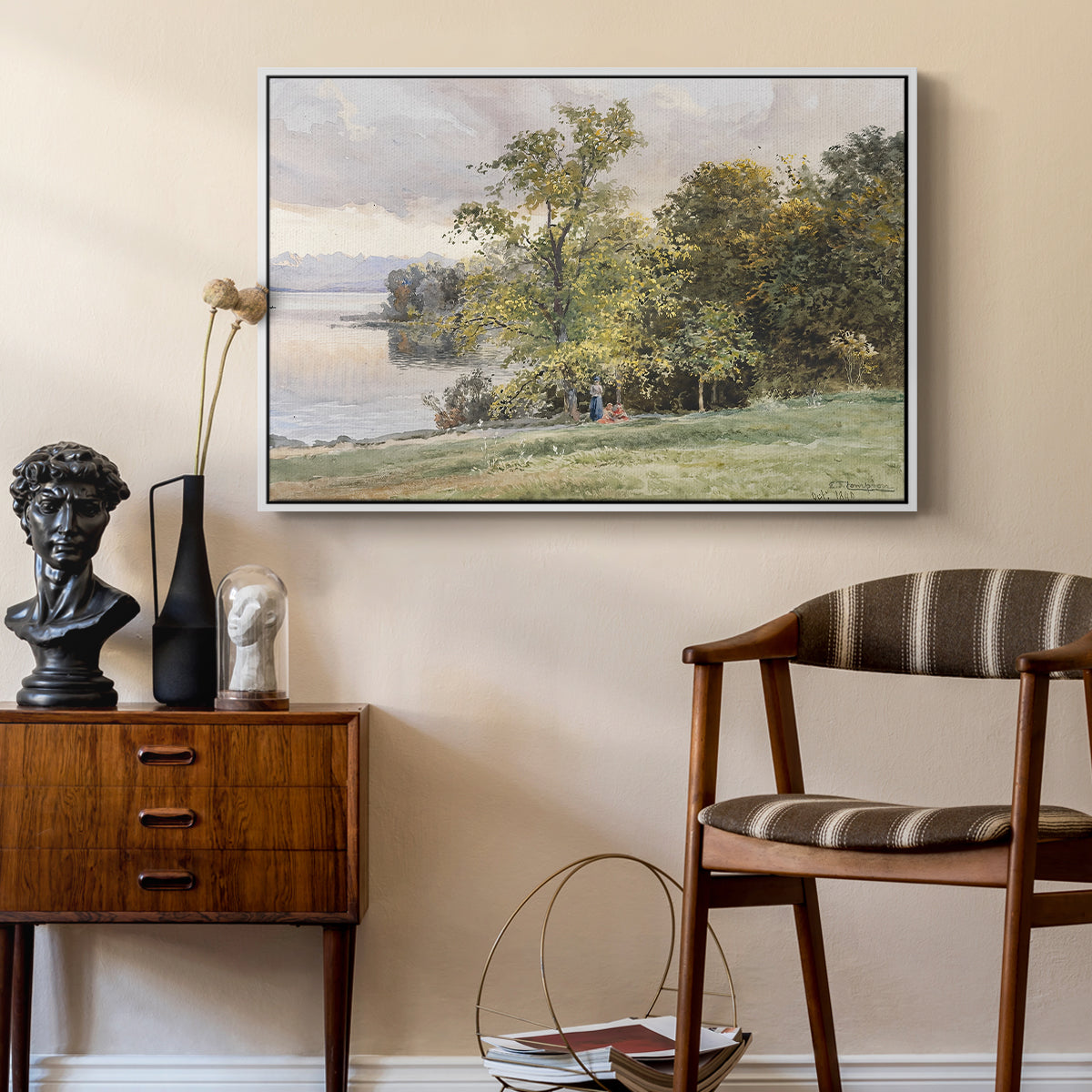 Landscape at Lake Starnberg, 1890 by Edward Theodore Compton as a white floater framed canvas featuring a natural setting with water, trees, and open sky, styled above a mid-century console in a contemporary living area.
