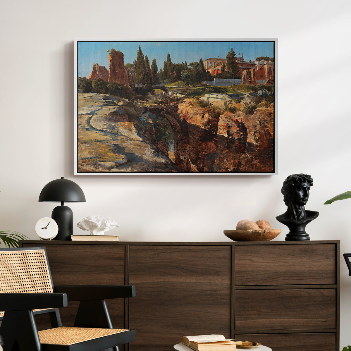 Palatine in Rome, c. 1921 by Edward Theodore Compton displayed in a white floater framed canvas above a dark wood credenza in an entryway.