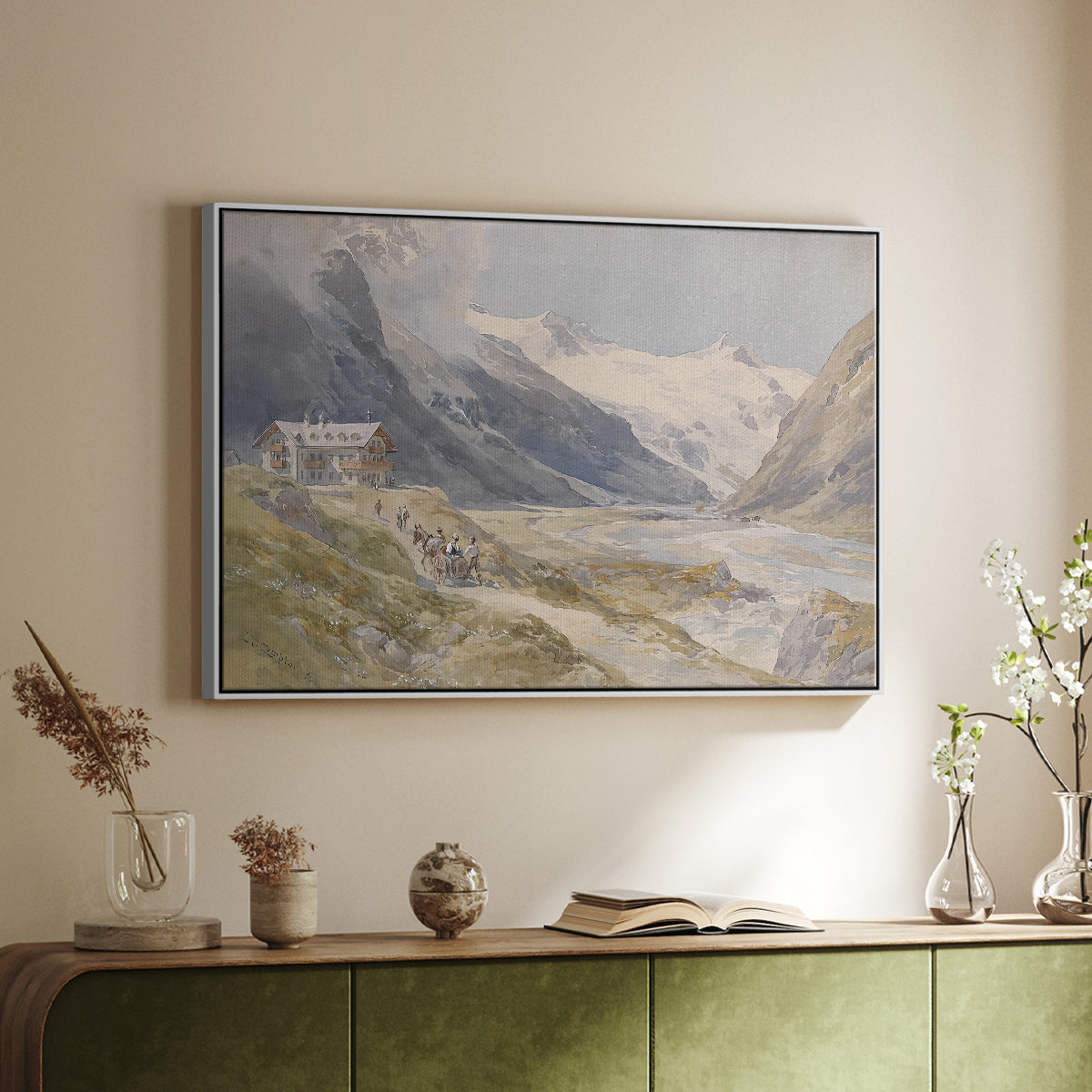 White floater framed canvas of Shepherds (Pasterze), c. 1921 by Edward Theodore Compton, featuring a pastoral mountain scene with figures tending livestock above a sideboard in a softly lit hallway.