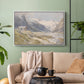 White floater framed canvas featuring a natural landscape with human presence among mountains, displayed above a sofa in a modern living room.