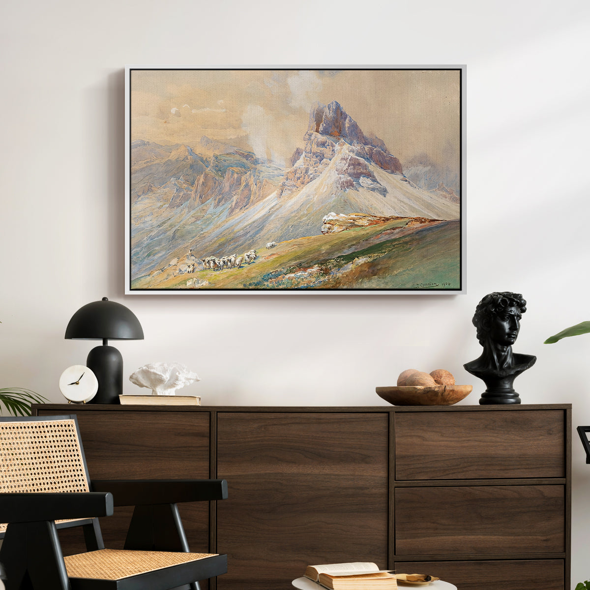 From the Dolomites, 1904 by Edward Theodore Compton displayed in a white floater framed canvas above a dark wood credenza in an entryway.
