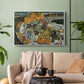 White floater framed canvas featuring an architectural scene with houses arranged in curved composition, displayed above a sofa in a modern living room.