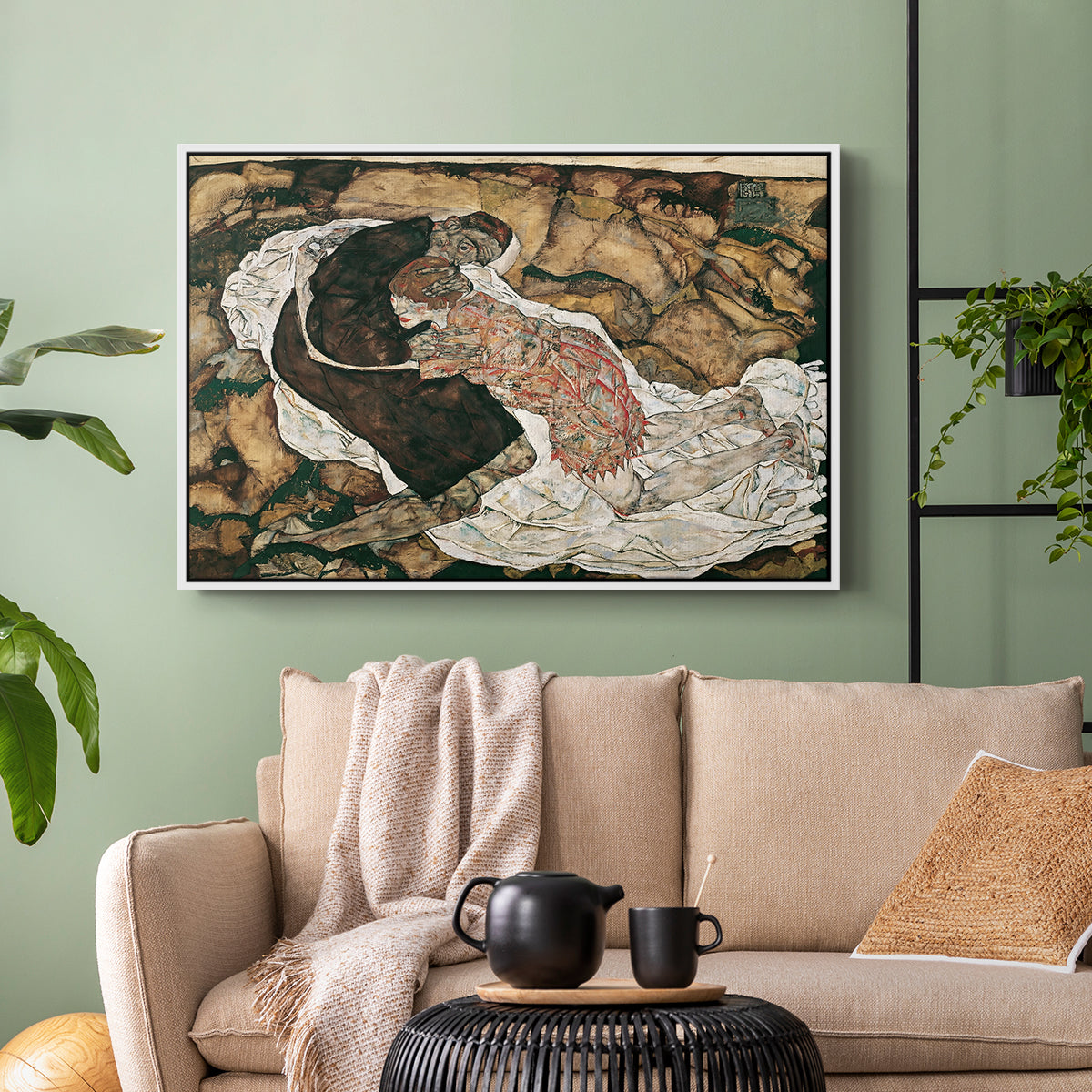 White floater framed canvas featuring an intense composition exploring life and death through figures, displayed above a sofa in a modern living room.