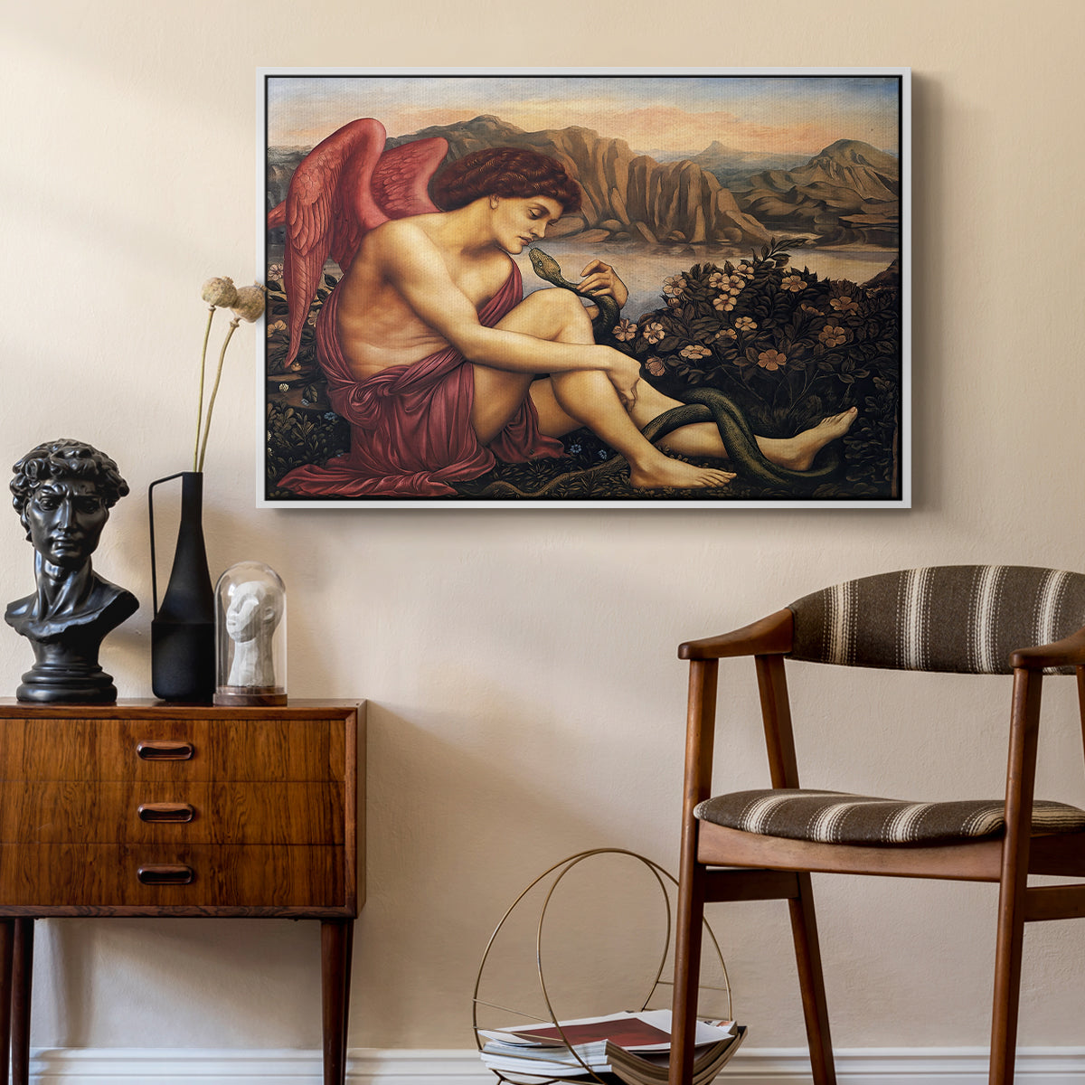The Angel with the Serpent, c. 1870-1875 by Evelyn De Morgan as a white floater framed canvas featuring a religious scene with angel defeating snake in dramatic pose, styled above a mid-century console in a contemporary living area.