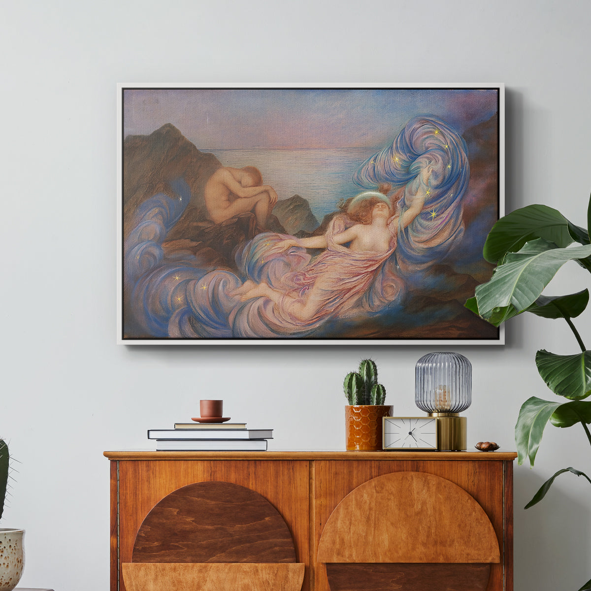 Twilight, 1914 by Evelyn De Morgan in a white floater framed canvas featuring a reclining female figure beneath glowing sky at twilight with soft colors, displayed above a wood console cabinet.