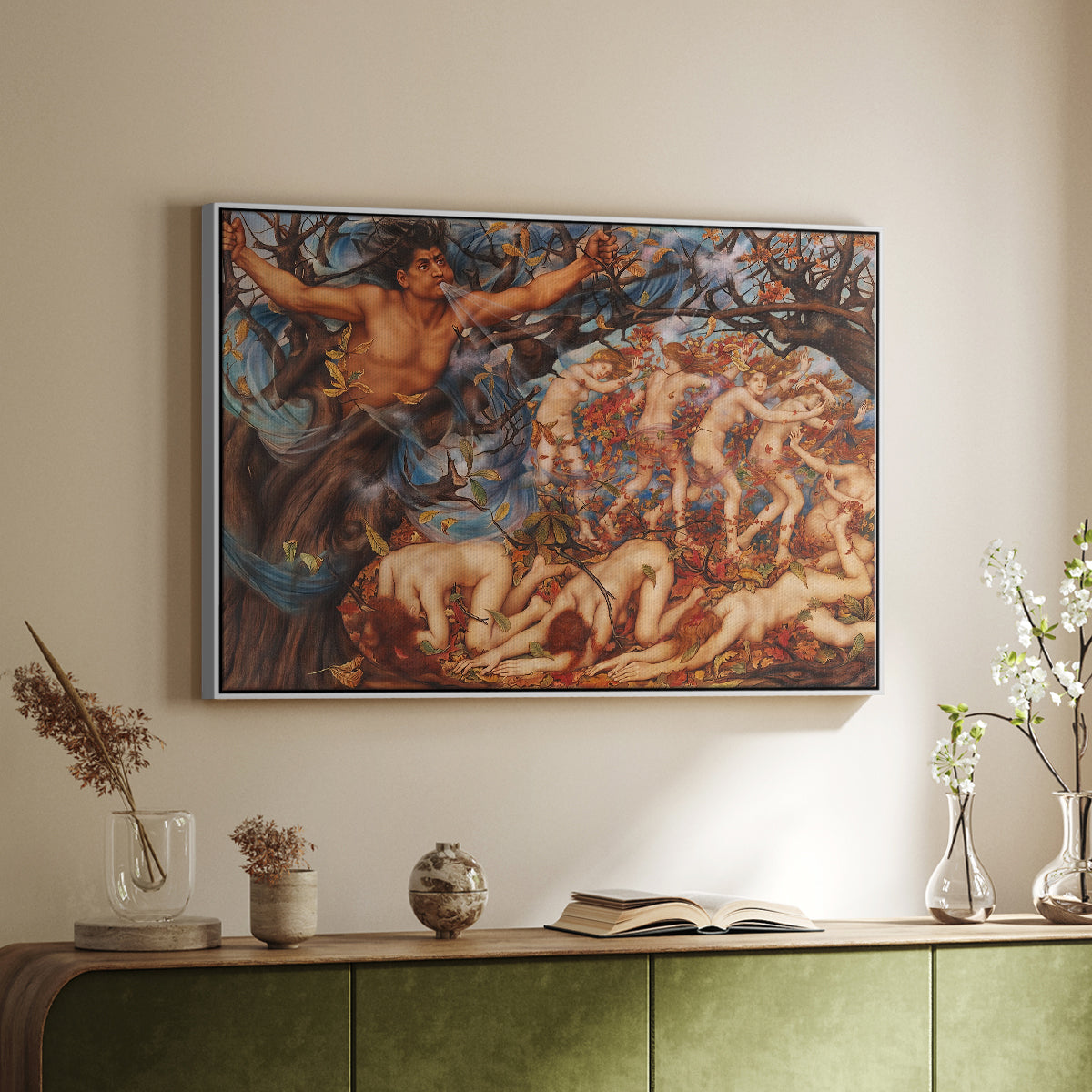 White floater framed canvas of Boreas and the Fallen Leaves, c. 1910-1914 by Evelyn De Morgan, featuring a mythological scene of wind god Boreas moving through autumn leaves above a sideboard in a softly lit hallway.
