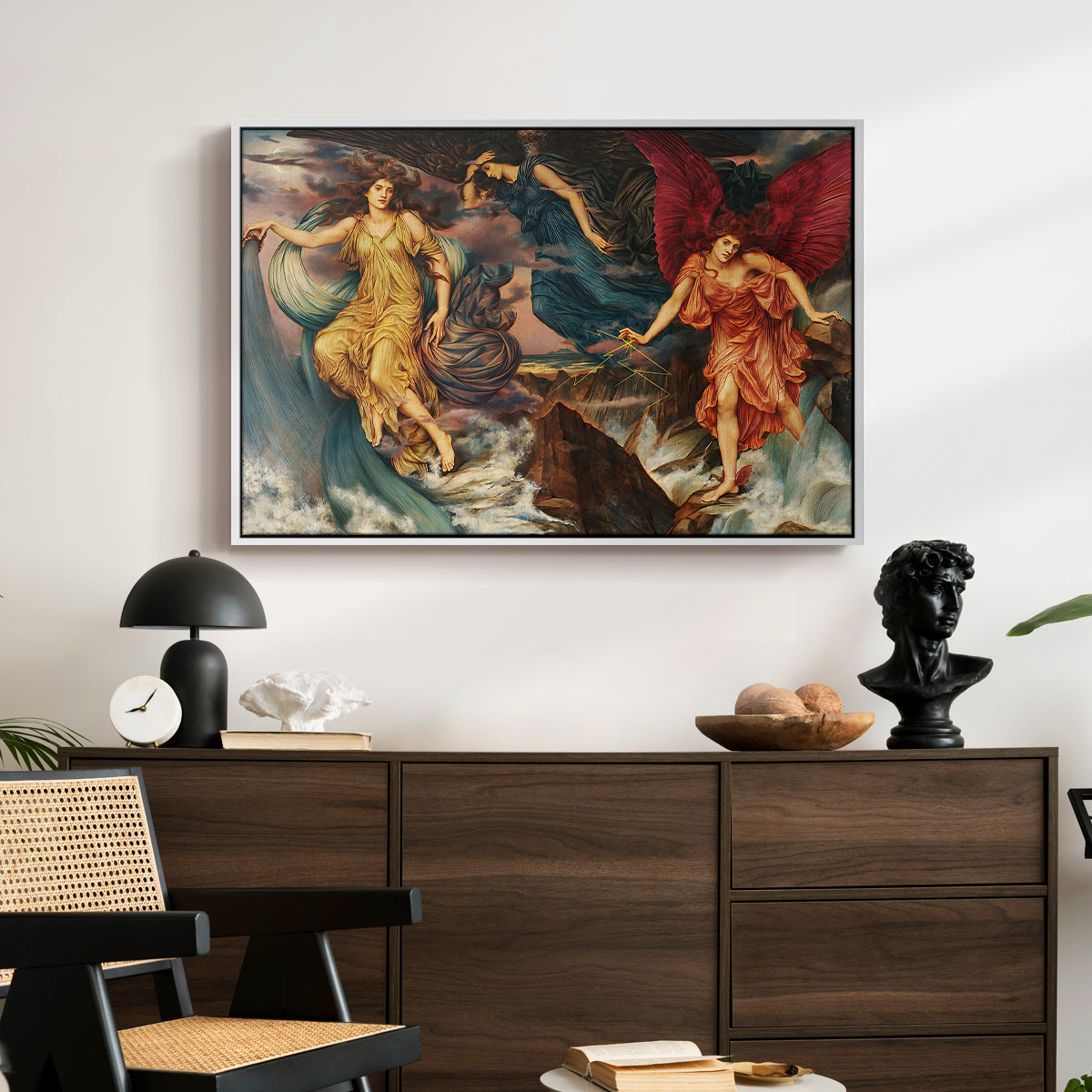The Storm Spirits, 1900 by Evelyn De Morgan displayed in a white floater framed canvas above a dark wood credenza in an entryway.