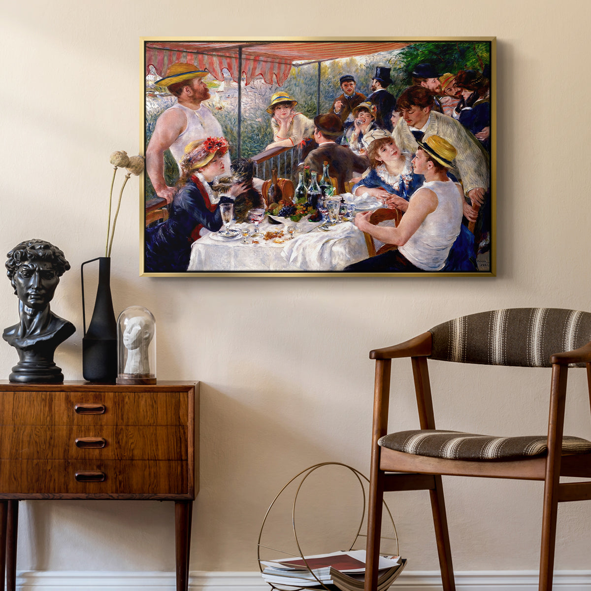 Luncheon of the Boating Party (Le Déjeuner des canotiers), 1880-1881 by Pierre-Auguste Renoir as a gold floater framed canvas featuring an impressionist scene of friends enjoying lunch with wine and conversation, styled above a mid-century console in a contemporary living area.