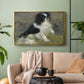 Gold floater framed canvas featuring an animal portrait of a dog in natural outdoor setting with soft light, displayed above a sofa in a modern living room.