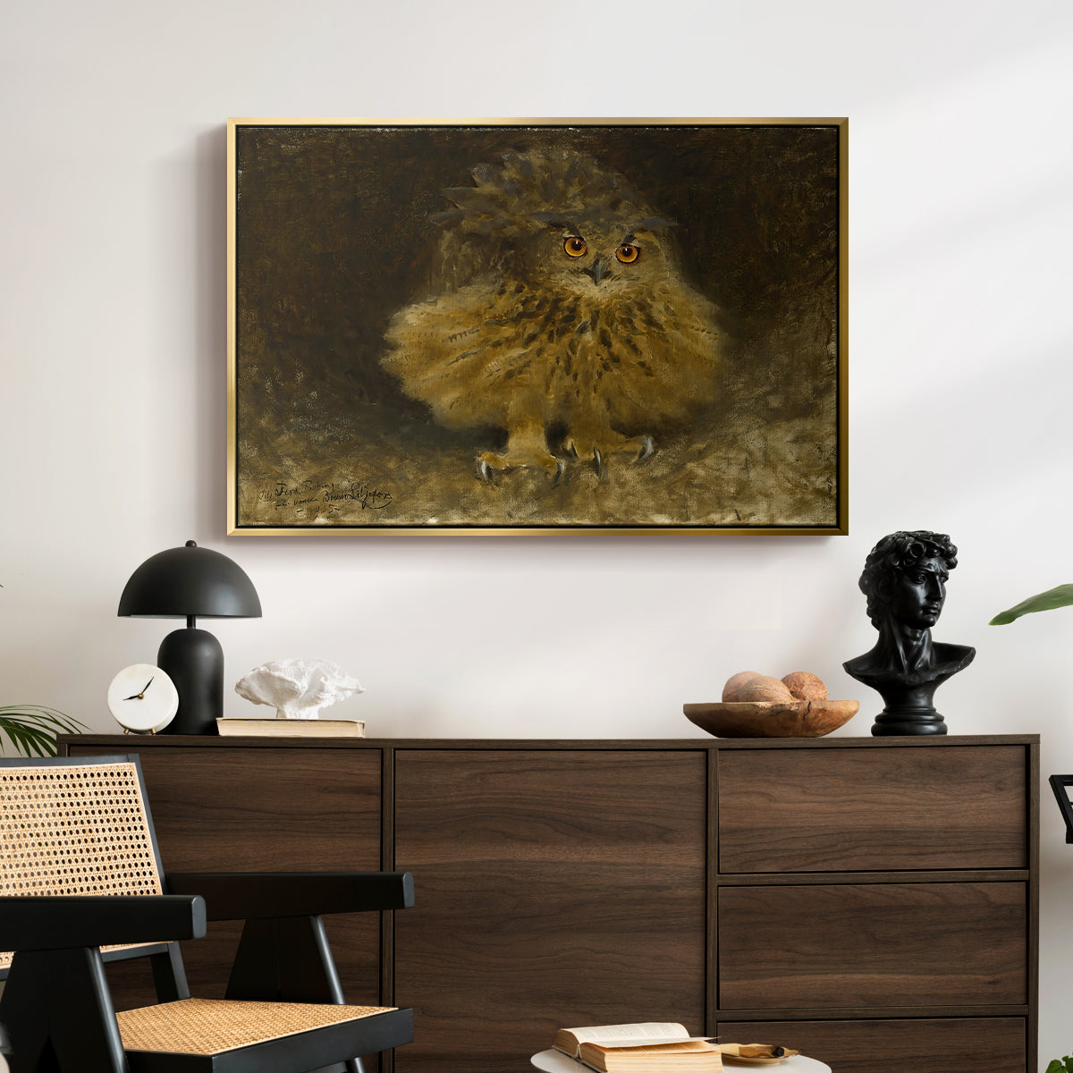 An Eagle Owl (Berguv), 1905 by Bruno Liljefors displayed in a gold floater framed canvas above a dark wood credenza in an entryway.