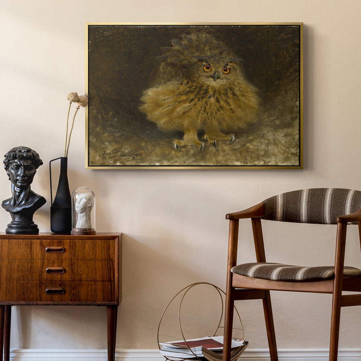 An Eagle Owl (Berguv), 1905 by Bruno Liljefors as a gold floater framed canvas featuring a bird of prey resting on tree branch with textured feathers, styled above a mid-century console in a contemporary living area.