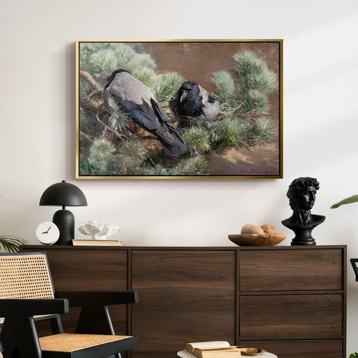 Hooded Crows (Kråkor), 1891 by Bruno Liljefors displayed in a gold floater framed canvas above a dark wood credenza in an entryway.