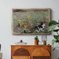 Cat on a Flowery Meadow, 1887 by Bruno Liljefors in a gold floater framed canvas featuring a cat crouching in a meadow filled with wildflowers and greenery, displayed above a wood console cabinet.