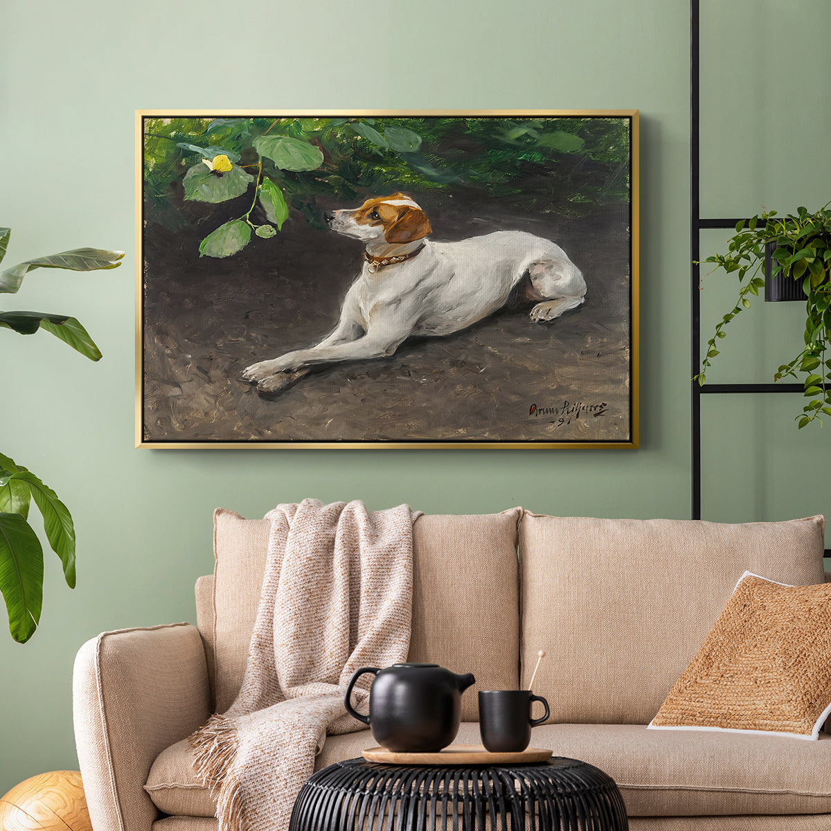 Gold floater framed canvas featuring a calm scene of dog reclining in open landscape, displayed above a sofa in a modern living room.
