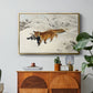 Fox in Snow Landscape, 1900 by Bruno Liljefors in a gold floater framed canvas featuring a fox running across snowy landscape with sparse vegetation, displayed above a wood console cabinet.