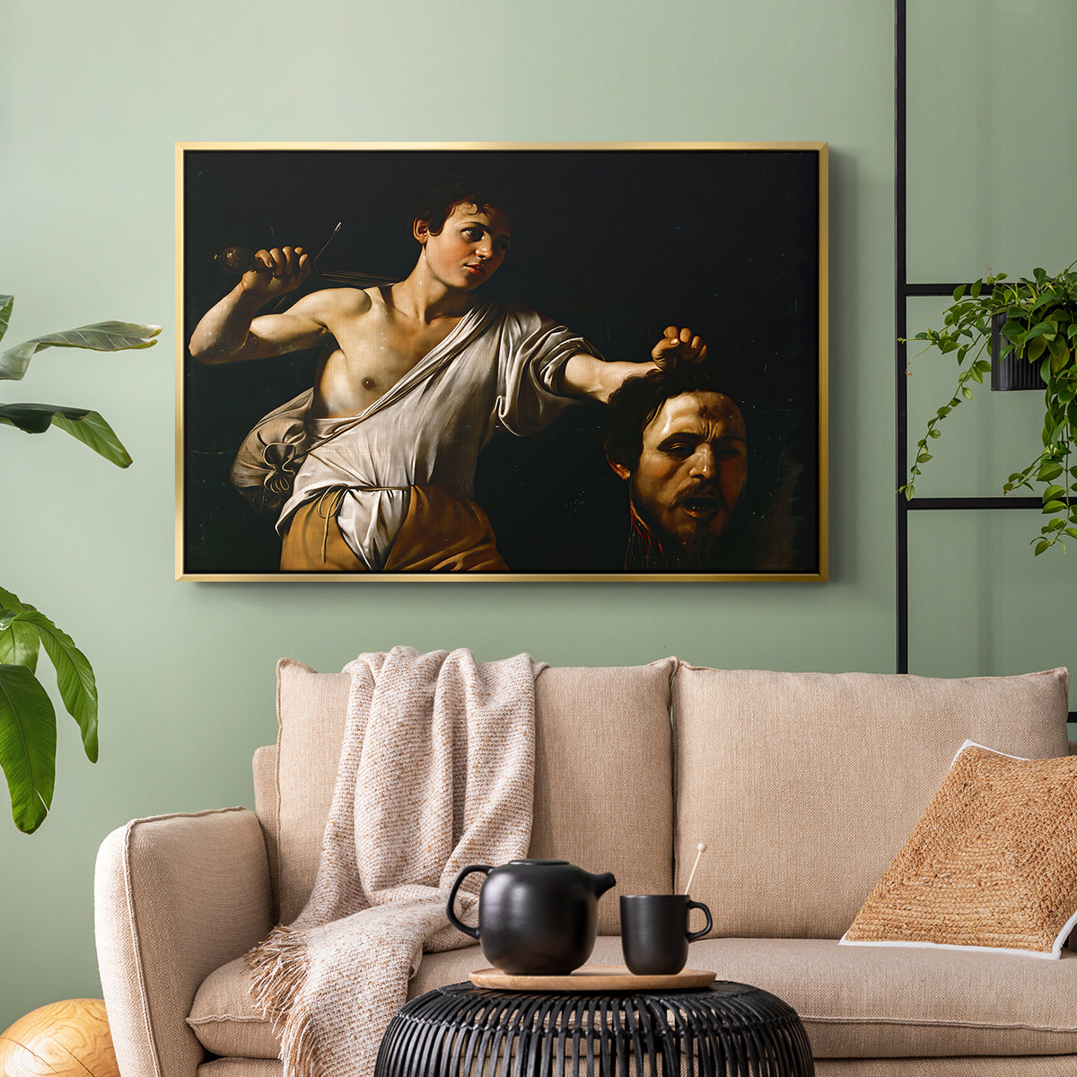 Gold floater framed canvas featuring an intense religious scene with figure emerging from darkness holding trophy, displayed above a sofa in a modern living room.