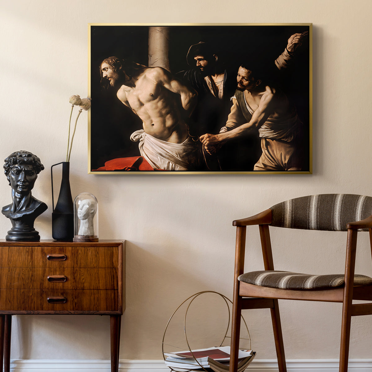The Flagellation of Christ at the Column (Rouen Version), 1606 by Caravaggio as a gold floater framed canvas featuring a biblical depiction of men whipping Christ tied to pillar, styled above a mid-century console in a contemporary living area.