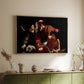 Gold floater framed canvas of The Sacrifice of Isaac (Uffizi Version), c. 1603 by Caravaggio, featuring a biblical scene of father about to sacrifice son as angel restrains him above a sideboard in a softly lit hallway.