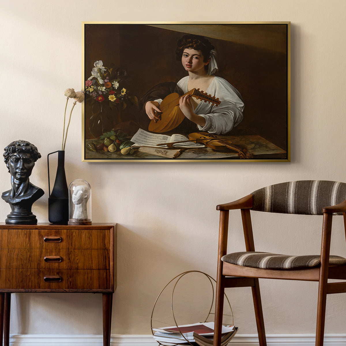 The Lute Player (Hermitage Version), c. 1596 by Caravaggio as a gold floater framed canvas featuring an intimate musical scene with instrument and decorative objects, styled above a mid-century console in a contemporary living area.