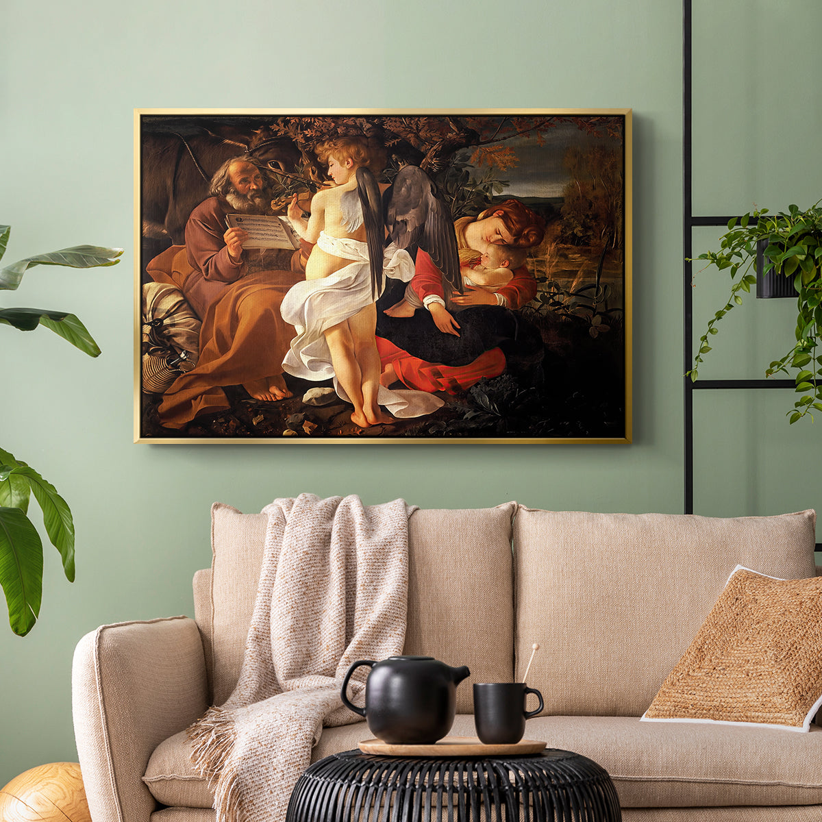 Gold floater framed canvas featuring a Baroque landscape with angel playing music for resting travelers, displayed above a sofa in a modern living room.