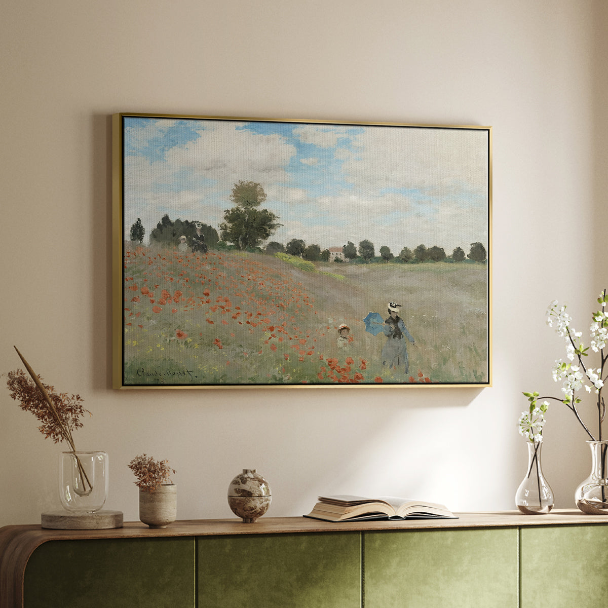 Gold floater framed canvas of The Poppy Field near Argenteuil, 1873 by Claude Monet, featuring an impressionist countryside scene with flowers and strolling figures above a sideboard in a softly lit hallway.