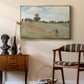 The Poppy Field near Argenteuil, 1873 by Claude Monet as a gold floater framed canvas featuring a bright meadow filled with poppies under open sky, styled above a mid-century console in a contemporary living area.
