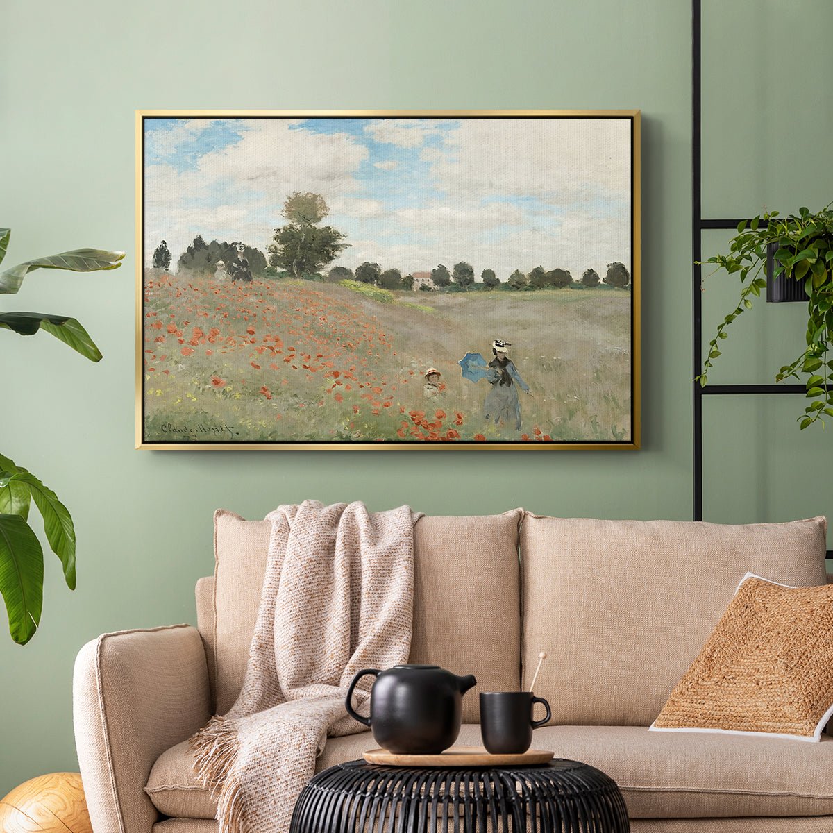 Gold floater framed canvas featuring a rural landscape with scattered figures among blooming flowers, displayed above a sofa in a modern living room.