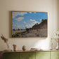 Gold floater framed canvas of The Beach at Honfleur, 1864 by Claude Monet, featuring an impressionist seaside with people and sailboats under bright sky above a sideboard in a softly lit hallway.