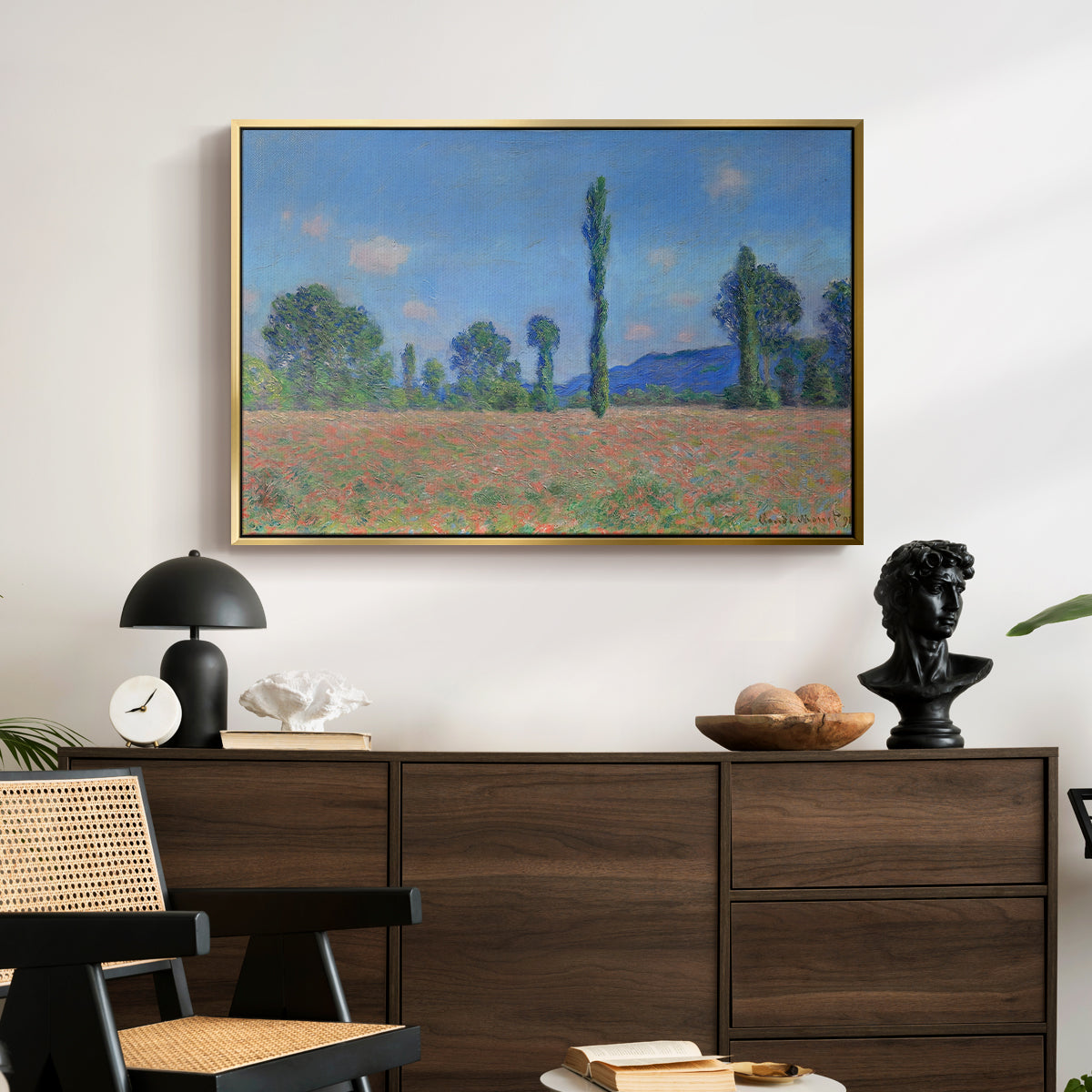 Poppy Field (Giverny), 1890-1891 by Claude Monet displayed in a gold floater framed canvas above a dark wood credenza in an entryway.