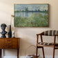 Banks of the Seine, Vétheuil, 1880 by Claude Monet as a gold floater framed canvas featuring a tranquil riverside scene with houses and vegetation, styled above a mid-century console in a contemporary living area.