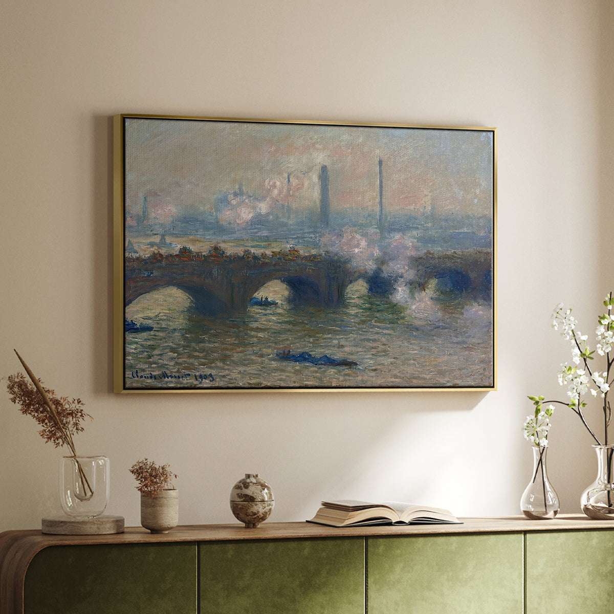 Gold floater framed canvas of Waterloo Bridge, Gray Day, 1903 by Claude Monet, featuring an impressionist depiction of bridge with soft gray tones and haze above a sideboard in a softly lit hallway.