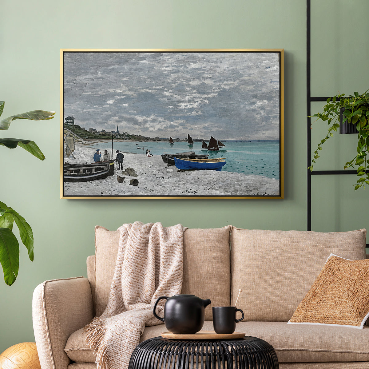 Gold floater framed canvas featuring an impressionist seaside gathering with flags and ocean view, displayed above a sofa in a modern living room.
