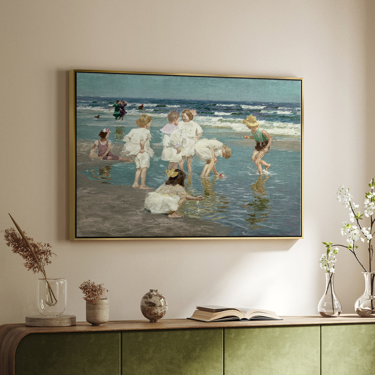 Gold floater framed canvas of A Holiday, c. 1915 by Edward Henry Potthast, featuring a beach scene with figures bathing and standing in waves under bright sky above a sideboard in a softly lit hallway.