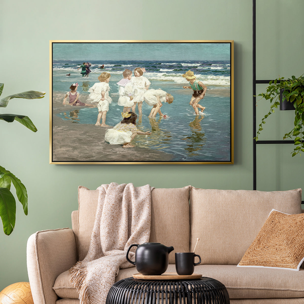 Gold floater framed canvas featuring a lively shoreline scene with people gathered in surf, displayed above a sofa in a modern living room.