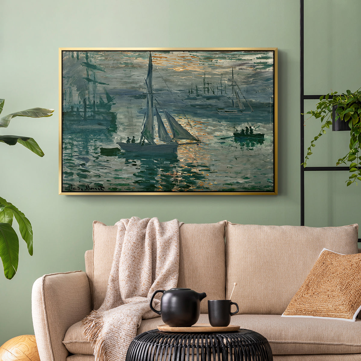 Gold floater framed canvas featuring an atmospheric ocean view with sun rising through haze, displayed above a sofa in a modern living room.