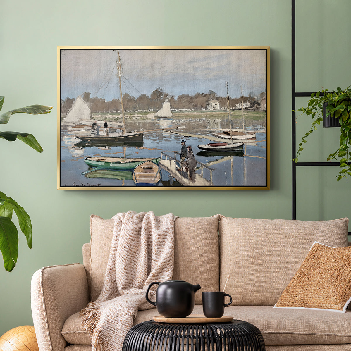 Gold floater framed canvas featuring a tranquil river setting with sailboats and shoreline, displayed above a sofa in a modern living room.