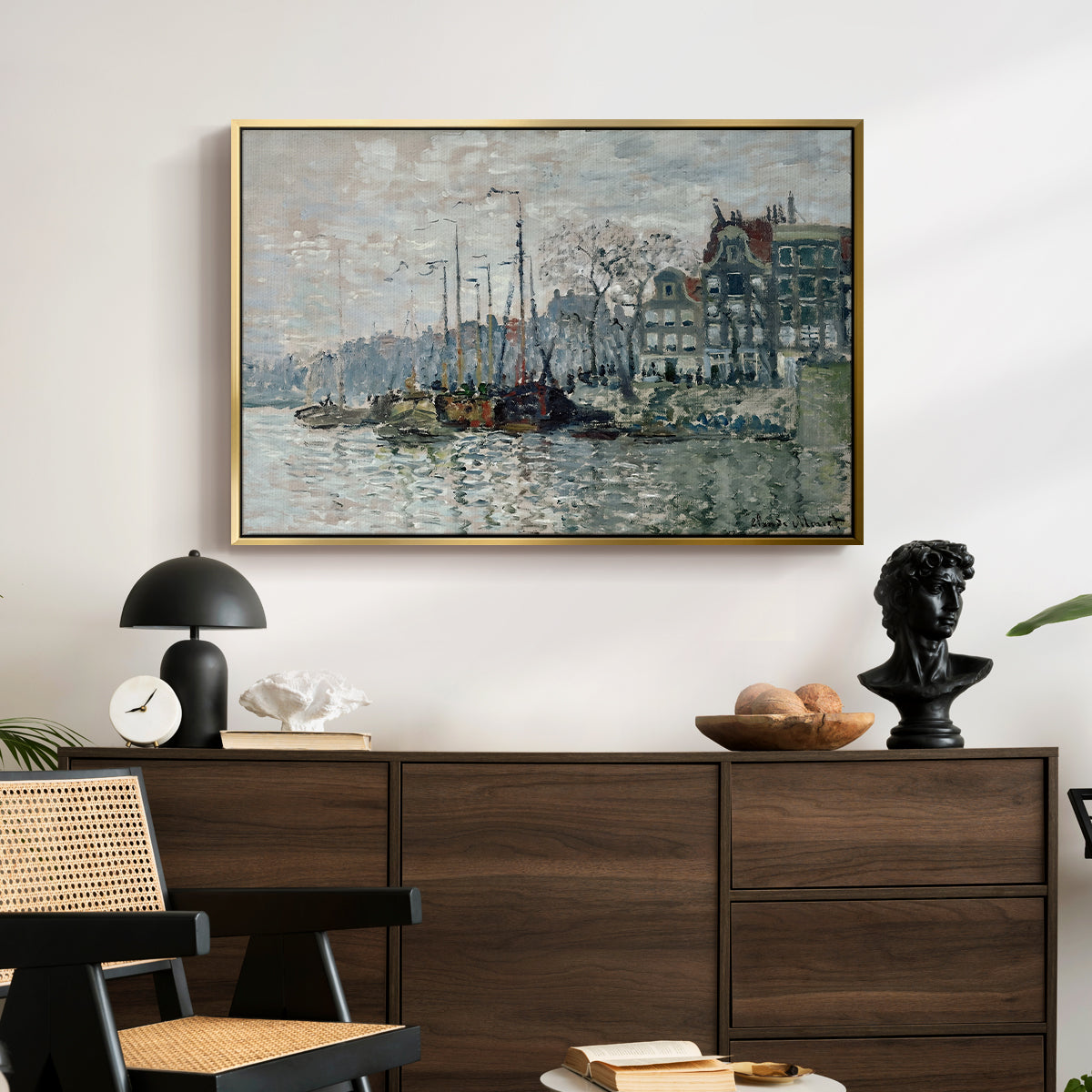 View of the Prins Hendrikkade and Kromme Waal in Amsterdam, 1874 by Claude Monet displayed in a gold floater framed canvas above a dark wood credenza in an entryway.