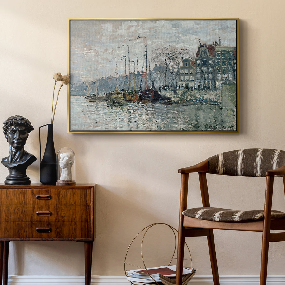 View of the Prins Hendrikkade and Kromme Waal in Amsterdam, 1874 by Claude Monet as a gold floater framed canvas featuring an urban waterway with docked boats and European buildings, styled above a mid-century console in a contemporary living area.