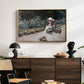 Young Girl in the Garden at Giverny, 1888 by Claude Monet displayed in a gold floater framed canvas above a dark wood credenza in an entryway.
