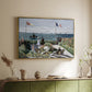 Gold floater framed canvas of Garden at Sainte-Adresse, 1867 by Claude Monet, featuring an impressionist coastal garden with people and ocean view above a sideboard in a softly lit hallway.