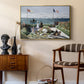 Garden at Sainte-Adresse, 1867 by Claude Monet as a gold floater framed canvas featuring a vibrant garden scene with colorful blooms and distant sea, styled above a mid-century console in a contemporary living area.