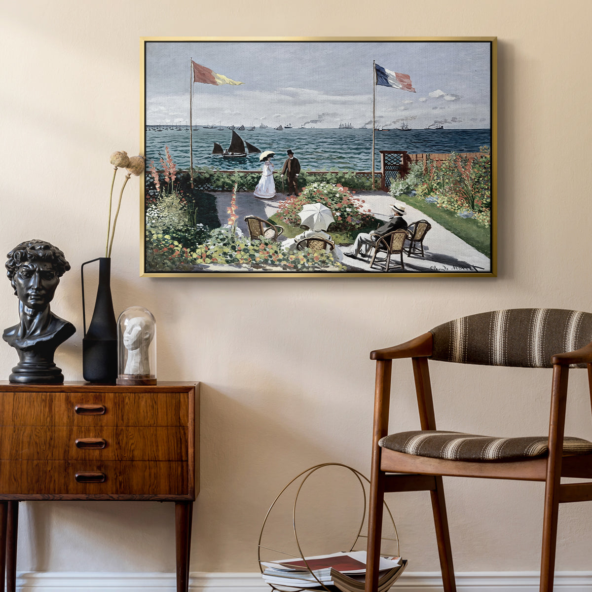 Garden at Sainte-Adresse, 1867 by Claude Monet as a gold floater framed canvas featuring a vibrant garden scene with colorful blooms and distant sea, styled above a mid-century console in a contemporary living area.