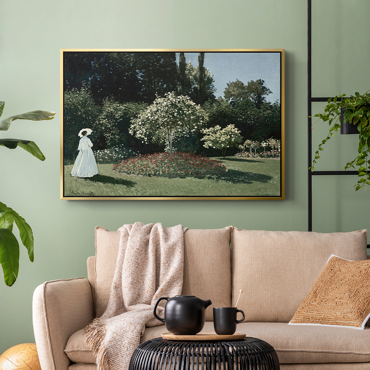 Gold floater framed canvas featuring a tranquil garden portrait with soft natural light, displayed above a sofa in a modern living room.