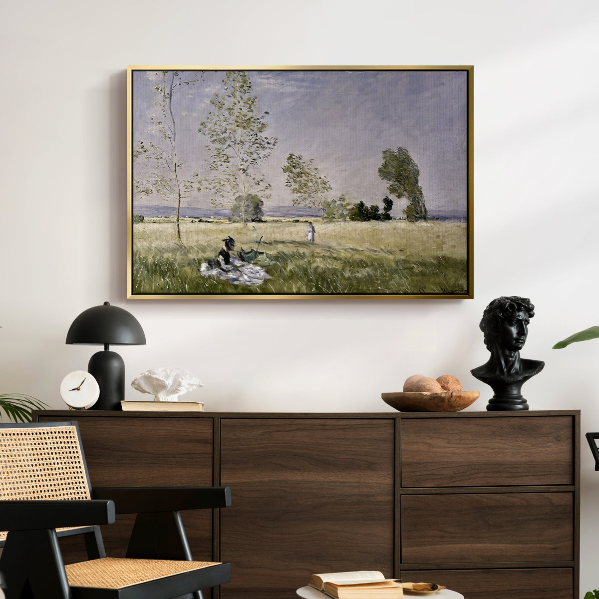 Summer (L'ete), 1874 by Claude Monet displayed in a gold floater framed canvas above a dark wood credenza in an entryway.
