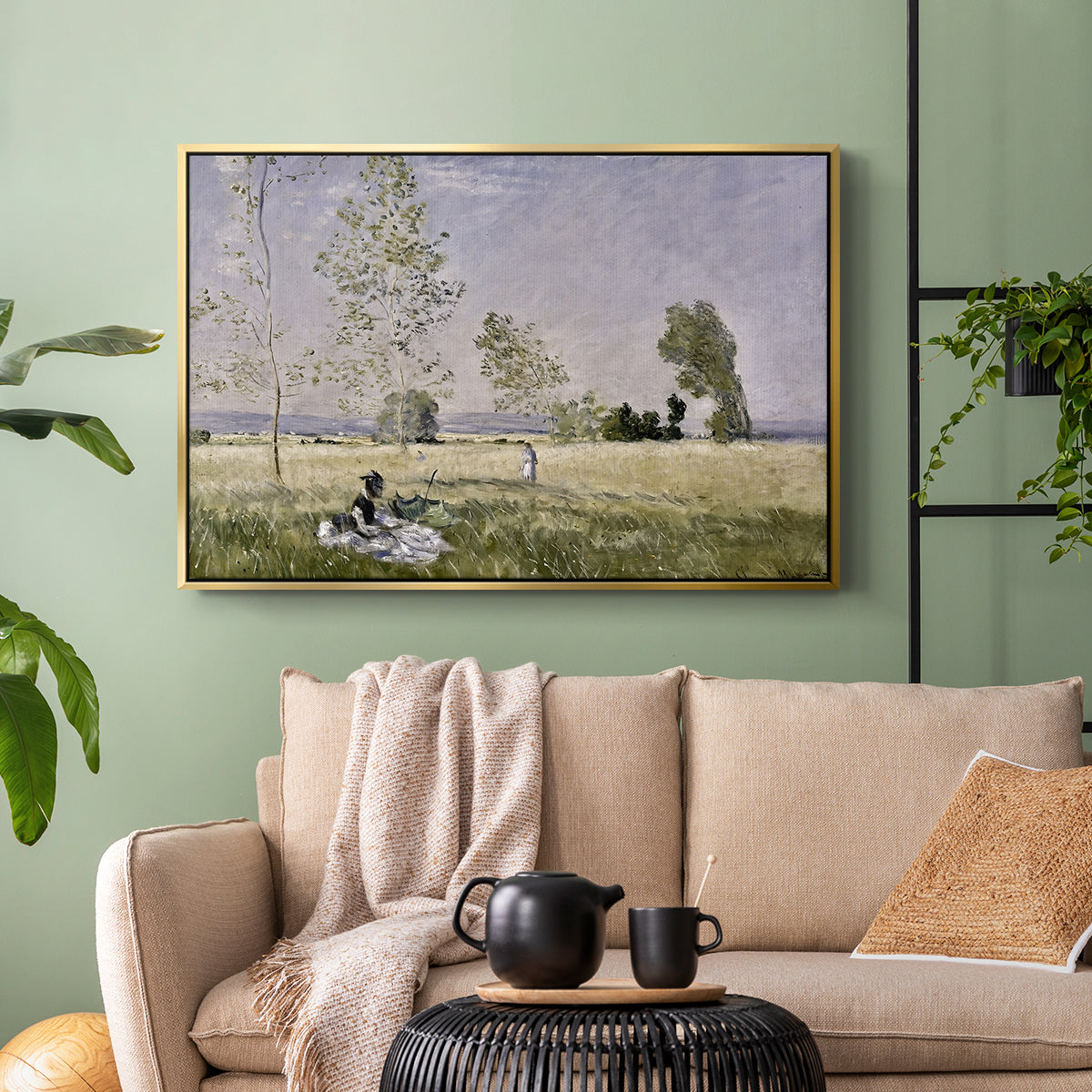 Gold floater framed canvas featuring a tranquil summer landscape with lone figure in nature, displayed above a sofa in a modern living room.